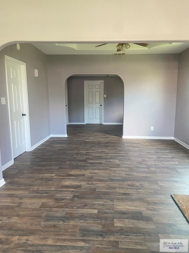 unfurnished room with dark hardwood / wood-style floors and ceiling fan