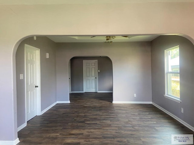 empty room with dark wood-type flooring