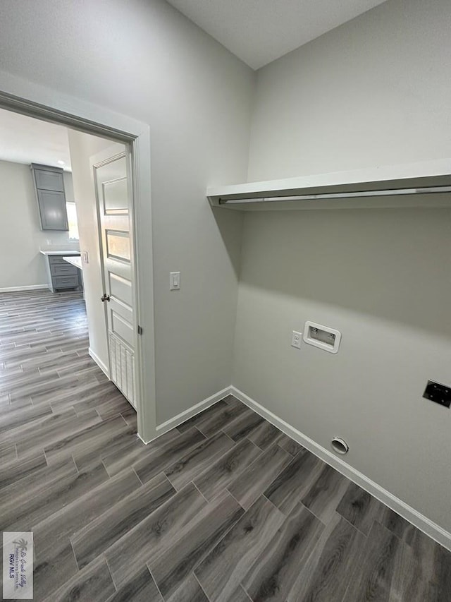 laundry room with electric dryer hookup, hookup for a washing machine, and dark wood-type flooring