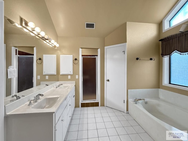 bathroom with tile patterned floors, vanity, lofted ceiling, and shower with separate bathtub