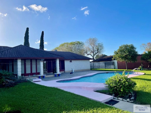 view of pool with a yard and a patio