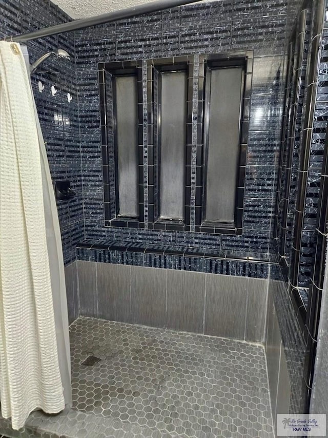 bathroom with tile patterned flooring and a shower