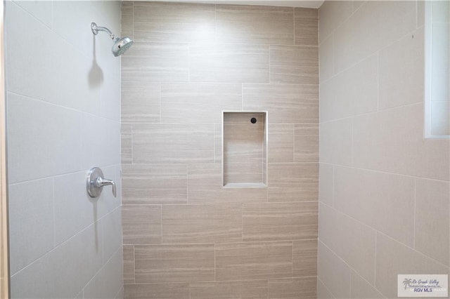 bathroom with a tile shower