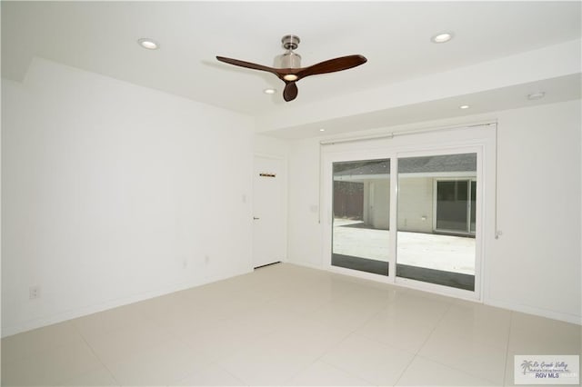 empty room with ceiling fan and light tile patterned flooring