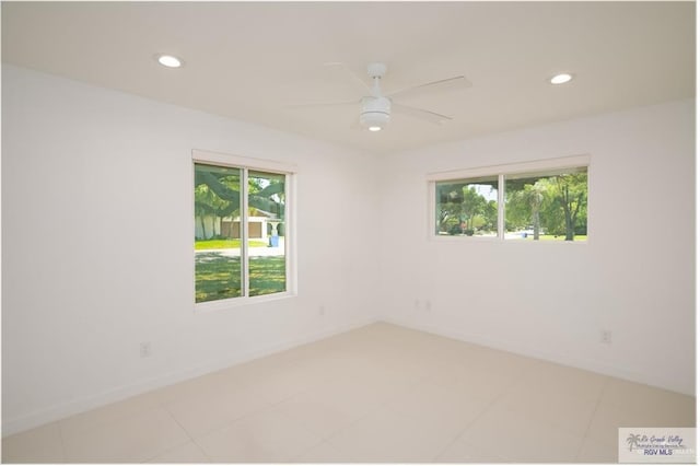 empty room featuring ceiling fan and light tile patterned floors