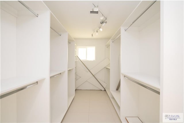 spacious closet with light tile patterned flooring