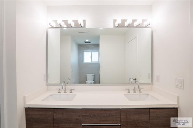 bathroom with vanity and toilet