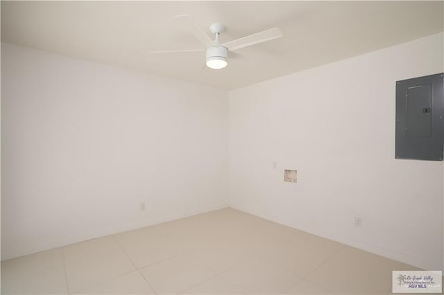 tiled spare room with ceiling fan and electric panel