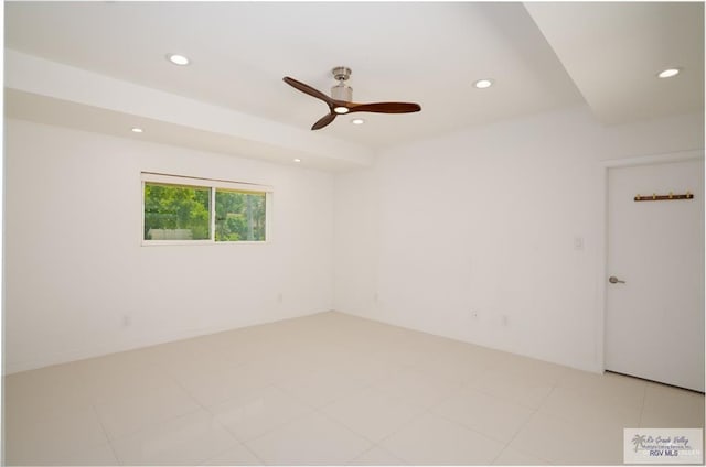 empty room with ceiling fan and light tile patterned flooring