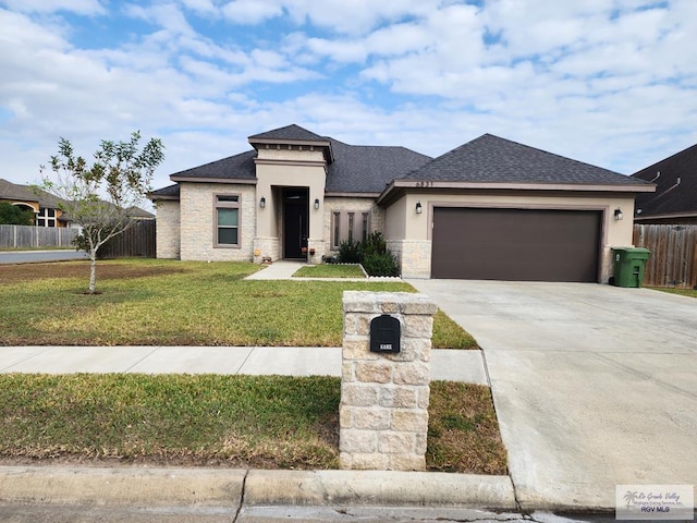 prairie-style house with a garage and a front lawn