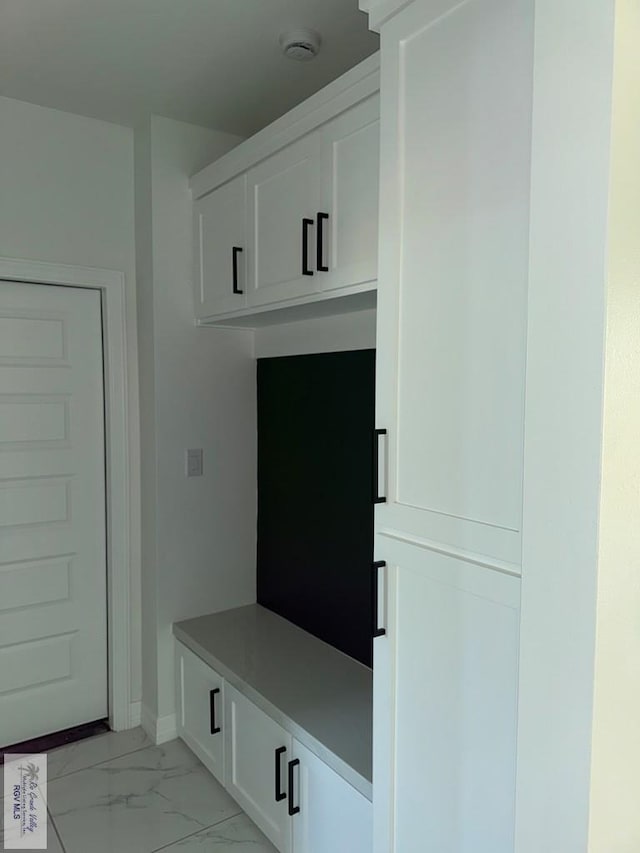 9464 S Queen Palm, Los Fresnos, TX 78566 - mudroom featuring light marble finish flooring and baseboards