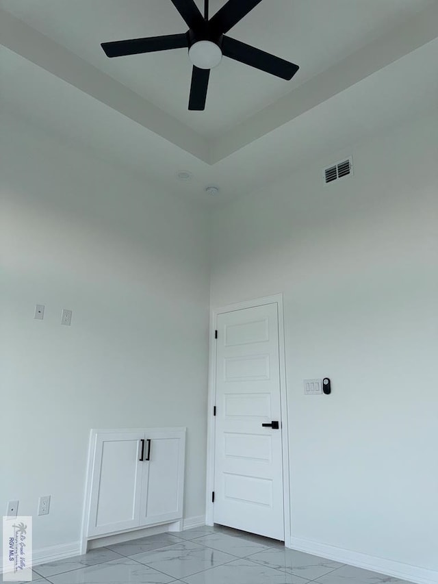 9464 S Queen Palm, Los Fresnos, TX 78566 - empty room with baseboards, a ceiling fan, and light marble finish floors