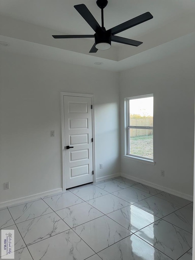 9464 S Queen Palm, Los Fresnos, TX 78566 - spare room featuring baseboards, ceiling fan, and light marble finish flooring