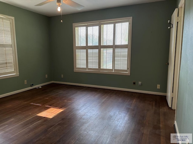1406 E Bowie Ave, Harlingen, TX 78550 - unfurnished room featuring dark wood-type flooring, a ceiling fan, and baseboards