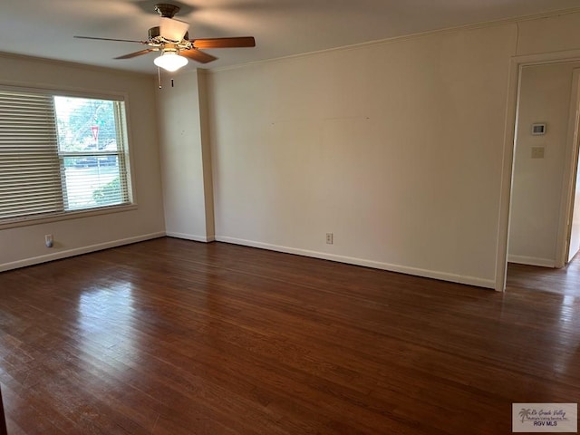 1406 E Bowie Ave, Harlingen, TX 78550 - empty room featuring dark wood-type flooring, baseboards, and a ceiling fan
