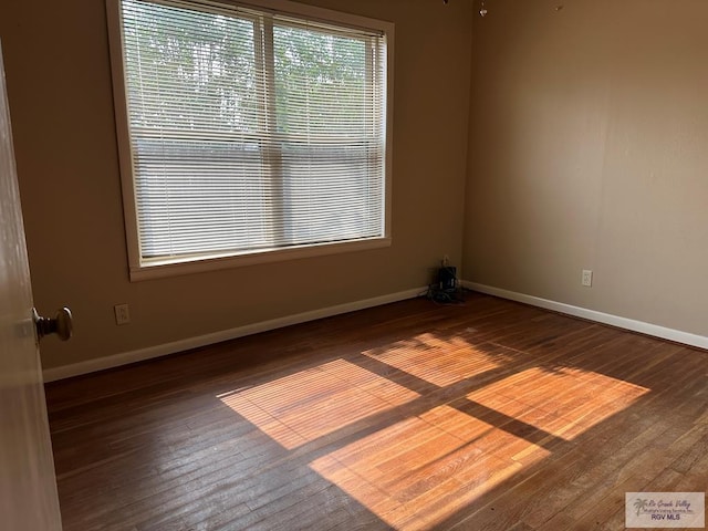 1406 E Bowie Ave, Harlingen, TX 78550 - empty room featuring hardwood / wood-style flooring and baseboards