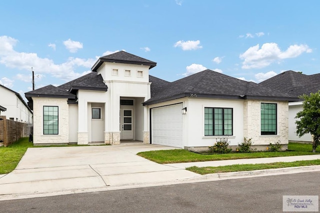 3515 S Elevation Dr, Edinburg, TX 78542 - view of front of home with an attached garage, roof with shingles, concrete driveway, and stone siding