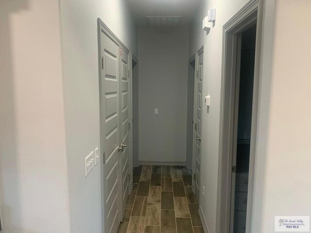 corridor with dark wood-type flooring