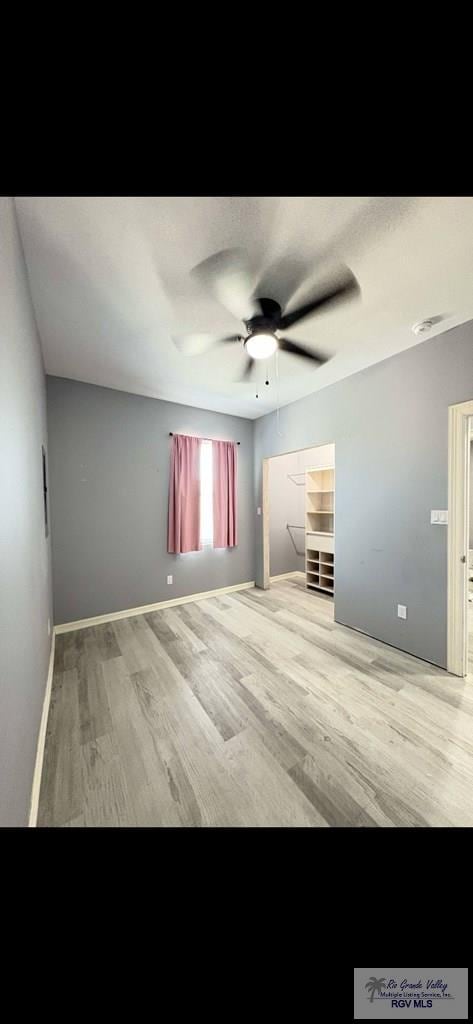 702 S California St, Harlingen, TX 78552 - spare room with wood finished floors, ceiling fan, and baseboards