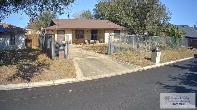 view of front of property featuring a fenced front yard and a gate