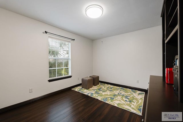 spare room with dark wood-type flooring