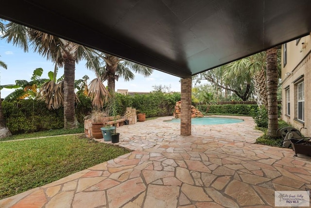 view of patio with a fenced in pool