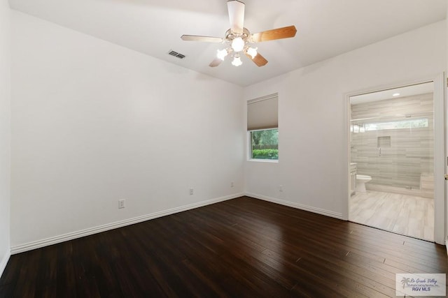 unfurnished bedroom featuring wood-type flooring, ensuite bathroom, and ceiling fan