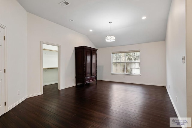 unfurnished living room with dark hardwood / wood-style floors and vaulted ceiling