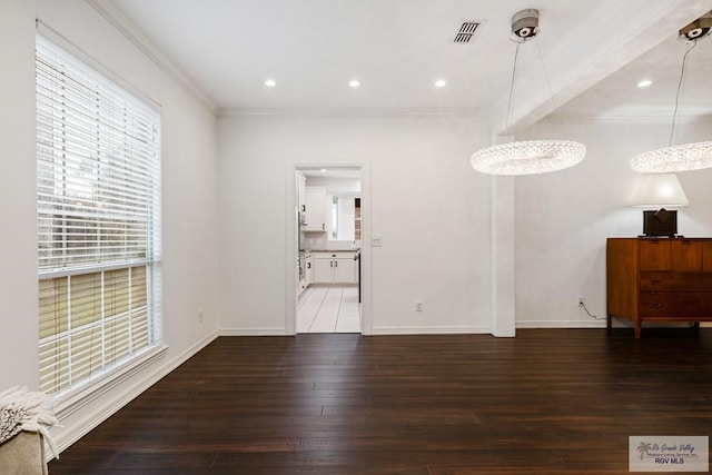 unfurnished living room featuring crown molding and dark wood-type flooring