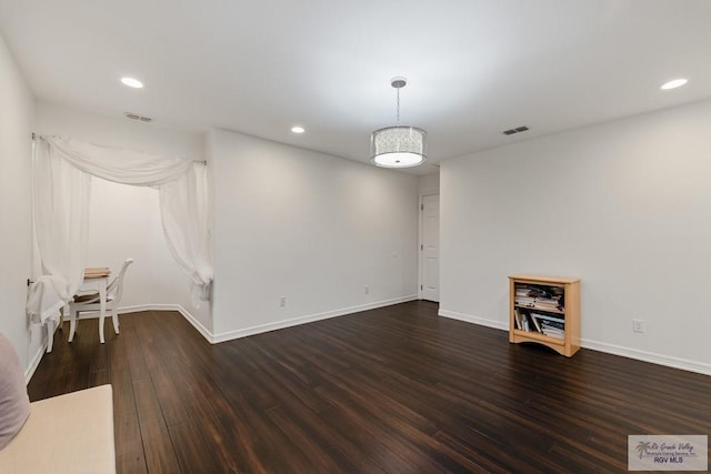 spare room with dark hardwood / wood-style floors