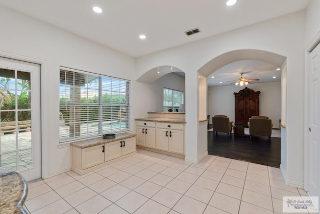 bathroom with tile patterned flooring, a wealth of natural light, and ceiling fan