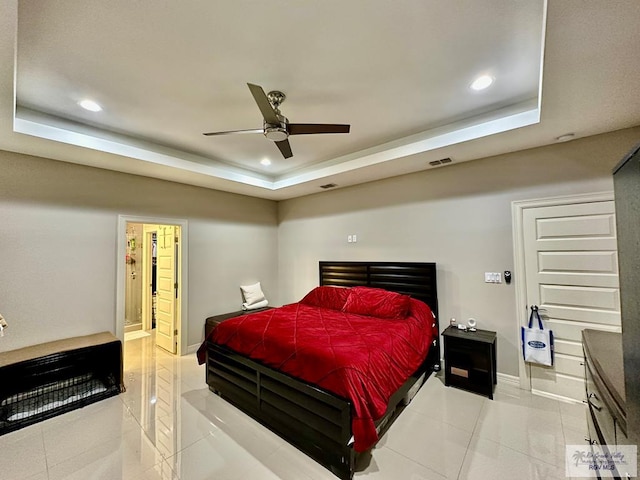 bedroom featuring light tile patterned floors, baseboards, a raised ceiling, and recessed lighting