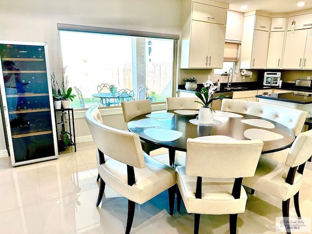 dining space featuring baseboards and light tile patterned floors