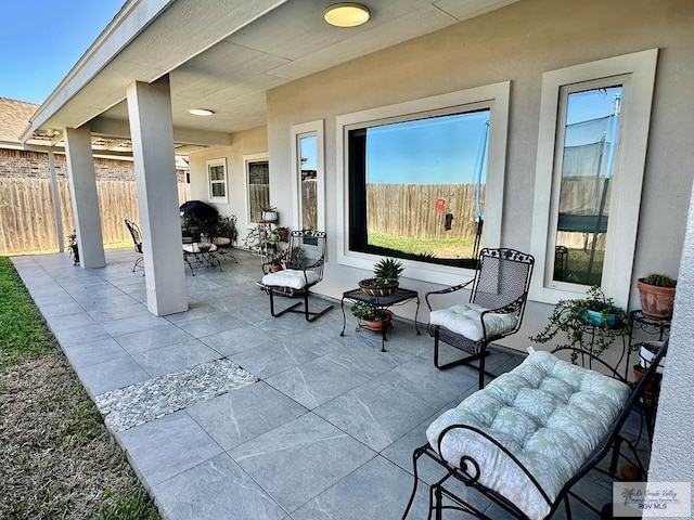 view of patio featuring fence