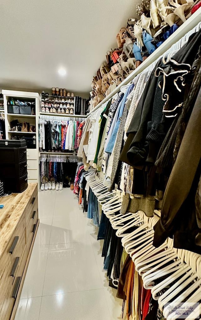 walk in closet featuring tile patterned flooring