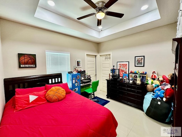 bedroom with tile patterned floors, ceiling fan, a raised ceiling, and recessed lighting