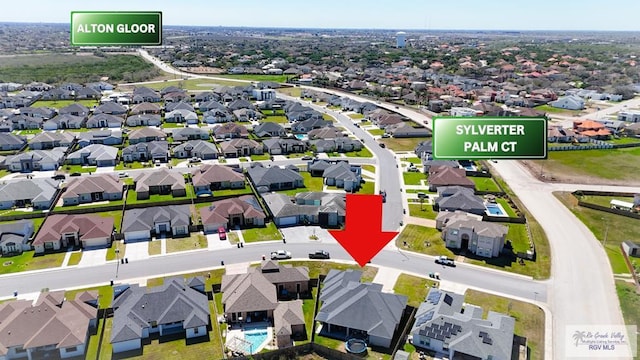 birds eye view of property with a residential view