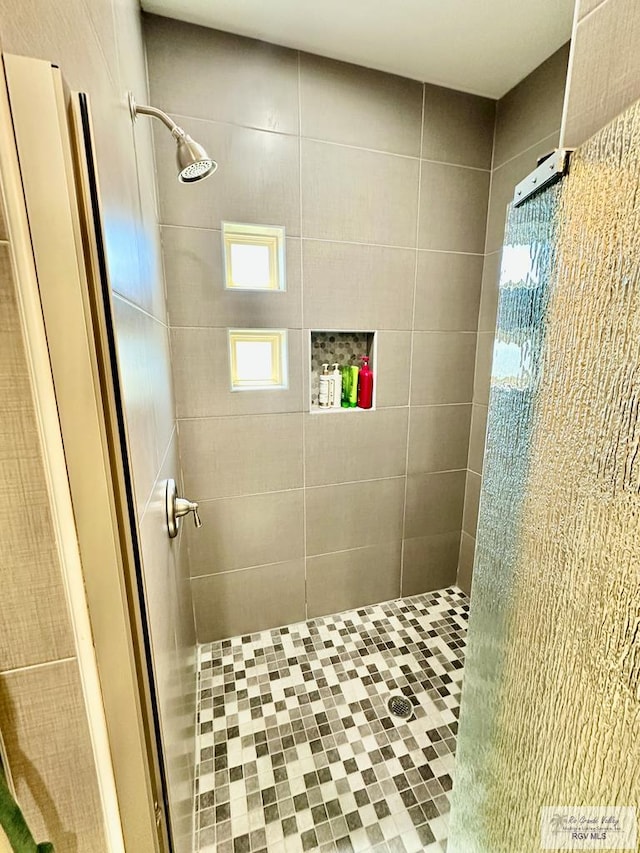 bathroom with tiled shower