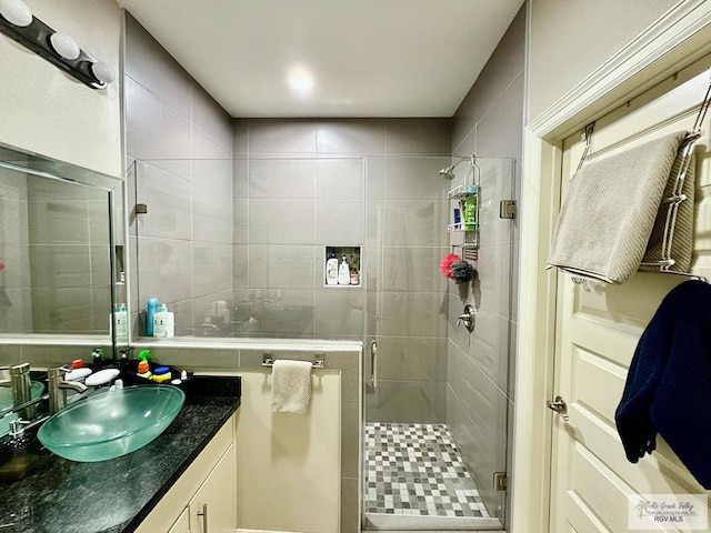 full bathroom featuring a shower stall and vanity