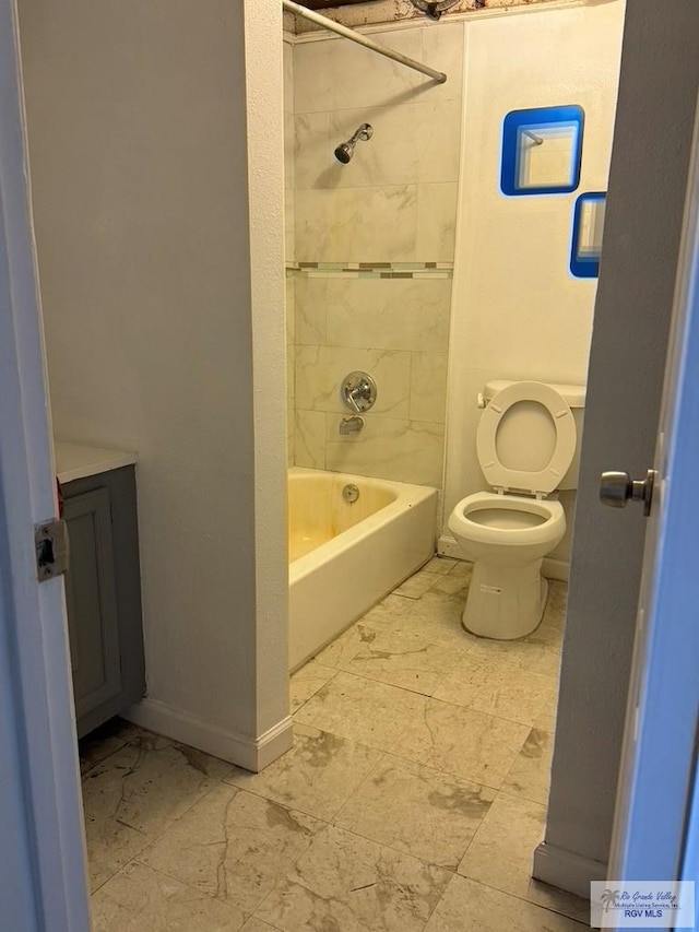 bathroom with tiled shower / bath combo and toilet