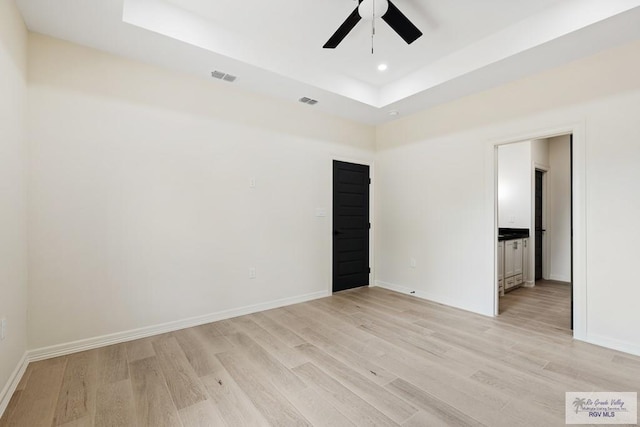 1209 Bridle Way, San Benito, TX 78586 - unfurnished room featuring light wood-style floors, ceiling fan, a raised ceiling, and recessed lighting