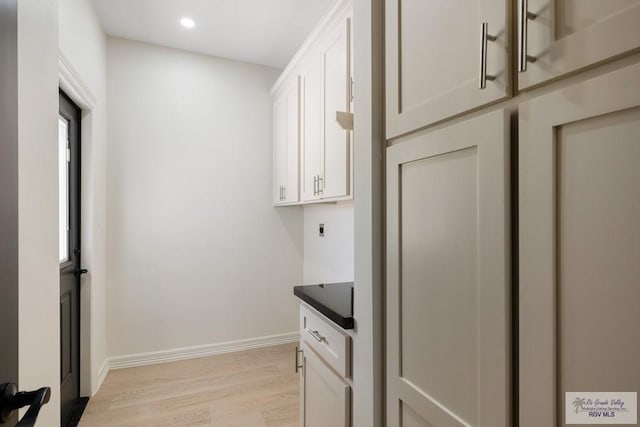 1209 Bridle Way, San Benito, TX 78586 - laundry room with electric dryer hookup, light wood-style floors, recessed lighting, and cabinet space