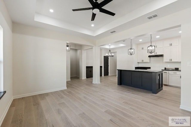 1209 Bridle Way, San Benito, TX 78586 - kitchen featuring a chandelier, light wood-style flooring, recessed lighting, open floor plan, and white cabinetry