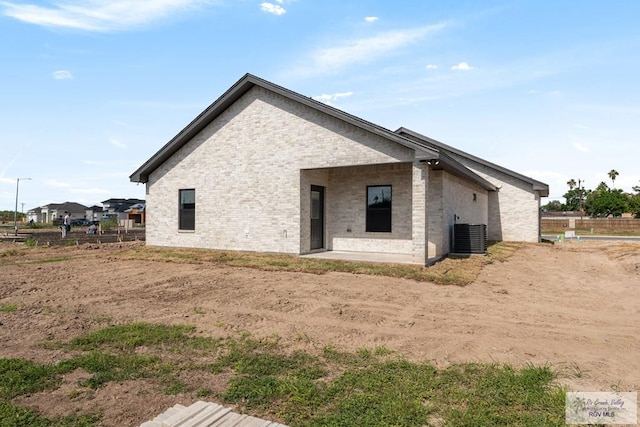 1209 Bridle Way, San Benito, TX 78586 - rear view of property featuring brick siding