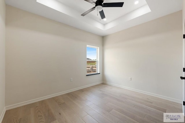 1209 Bridle Way, San Benito, TX 78586 - unfurnished room with light wood-style floors, ceiling fan, recessed lighting, and a tray ceiling