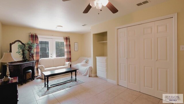 sitting room with ceiling fan, french doors, and light tile patterned floors