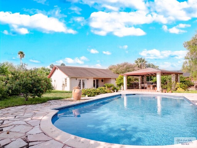 view of swimming pool featuring a gazebo, a patio, and an outdoor structure