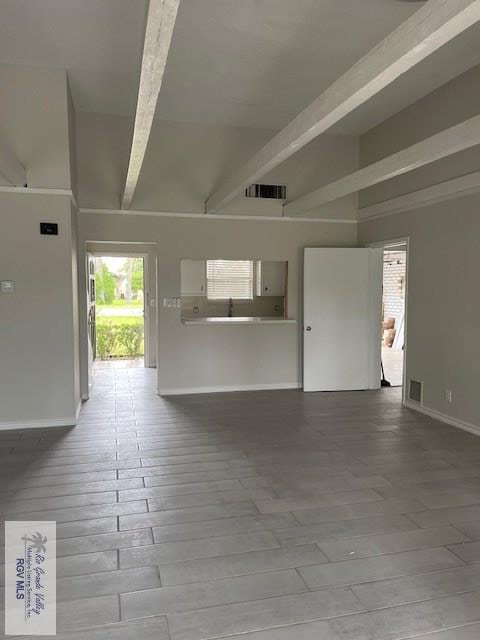 interior space with beamed ceiling, light hardwood / wood-style floors, and high vaulted ceiling