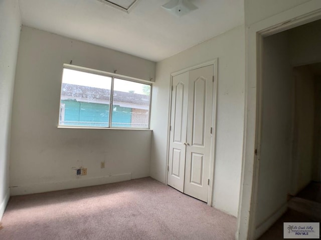 unfurnished bedroom with a closet and carpet floors