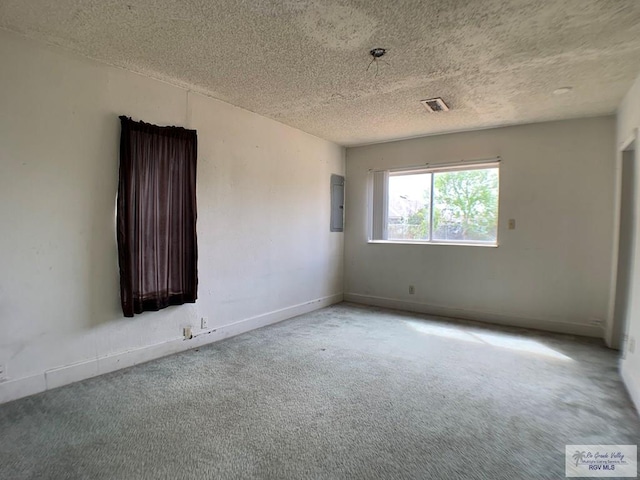 empty room with baseboards, carpet, visible vents, and a textured ceiling